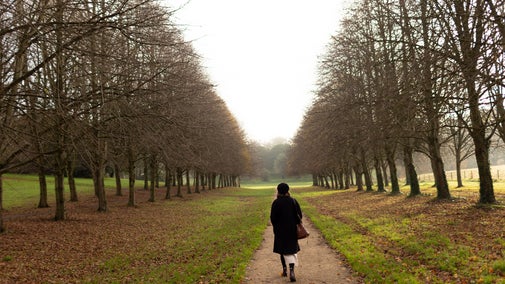 A woman walking down Lime Tree Walk at Castle Ward